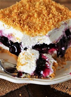 a piece of ice cream cake on a plate with a crumb topping and a fork