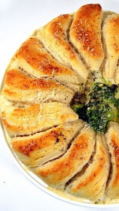 a white plate topped with bread and broccoli