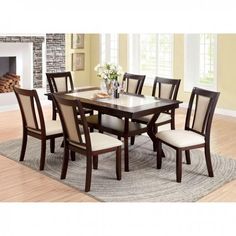 a dining room table with chairs around it