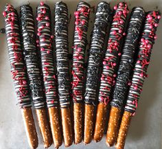 six pretzels with chocolate and sprinkles on them