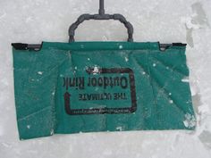 a green bag sitting on top of snow covered ground