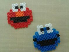 two legos made to look like sesame the cookie monster and elmo the blue bird