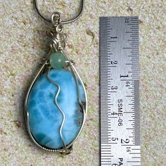 The most beautiful gemstone found only in the Dominican Republic, Larimar is a stone of coolness and calm, much like the native waters it resembles. Larimar is a powerful healer! It can help with panic attacks, anger, fear and other stress-related issues. Secure this unique and beautiful one-of-a-kind incredible Larimar pendant around your neck and breathe in the calm of the Caribbean ocean! Wrapped by our exclusive artist, when properly cared for this 925 sterling silver pendant will stand the test of time and make you the envy of everyone that sees you wear it. AA Grade Includes an 18” sterling silver chain Lead-free; nickel-safe Set in 925 sterling silver Pendant is 2.14”H (54.3mm) x .94”W (24mm) Comes in our exclusive luxury gift box Source: Dominican Republic Handmade by Moonstone by Caribbean Ocean, Larimar Pendant, Green Fluorite, The Dominican Republic, Luxury Gift Box, Beautiful One, Dominican Republic, Sterling Silver Chains, Sterling Silver Pendants