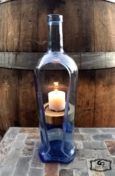 a candle is lit in a glass bottle