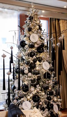 a decorated christmas tree with black and white ornaments