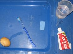 a toothbrush, soap and other items on a blue tray