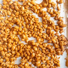 roasted peanuts on a baking sheet ready to be cooked in the oven for roasting