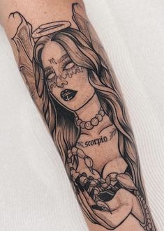 a woman with long hair and tattoos on her arm