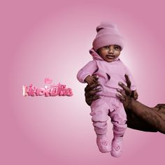 a man holding a baby in his arms and the word barbie above it is pink