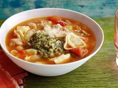 a white bowl filled with pasta and broccoli soup