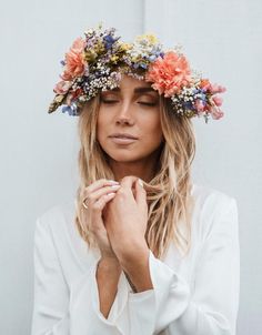 a woman wearing a flower crown on her head