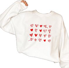 Winter White Tops With Heart Print, White Heart Print Tops For Winter, Winter White Tops With Heart Graphic, White Long Sleeve Tops With Heart Graphic, White Tops With Heart Graphic For Winter, White Long Sleeve Top With Heart Graphic, White Long Sleeve Tops With Heart Print, White Long Sleeve Top With Heart Print, Casual Heart Graphic Sweatshirt Gift