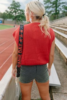 Gear up for game day with this red knit top featuring an embroidered "gameday" design in black. Show off your team spirit for the ULL Rajin' Cajuns with this sleeveless, stretchy top perfect for tailgates and football games. Get ready to cheer your team to victory in style! runs true to size with a roomie fit stretchy model, Kylee is wearing a size small Team Spirit Red Sleeveless Tops, Red Sleeveless Tops For College, Red Sleeveless College Tops, Casual Sleeveless Tops For Game Day, Trendy Red Top For Game Day, Trendy Red Tops For Game Day, Collegiate Red Sleeveless Top, Red Collegiate Sleeveless Top, Casual Knit Tops For College