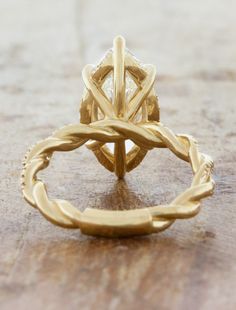 a gold ring sitting on top of a wooden table