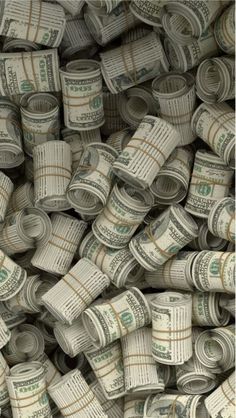 many stacks of rolled up dollar bills