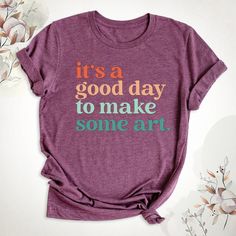 It's A Good Day To Make Some Art Shirt, Art Teacher Shirt, Artist T-Shirt, Art Lover Tee, Art Shirt, Gift For Teacher, Teacher Art Tshirt. Hello, Welcome to Blue Unique Boutique, your destination for unique and handcrafted shirts! I'm Eve! I have been thinking about creating my business for a long time and now I have taken the first step towards it and it gives me excitement. As a small business, I take pride in creating unique designs from the comfort of our homes. Each shirt is carefully craft Artistic Graphic Print Tops As Gift, Artistic Graphic Print Top As Gift, Artistic Graphic Print Top As A Gift, Artistic Cotton T-shirt With Text Print, Artistic Cotton T-shirt For Gift, Artistic Cotton T-shirt As A Gift, Artistic Cotton T-shirt, Artistic Short Sleeve Top With Text Print, Artistic Cotton Art With Letter Print