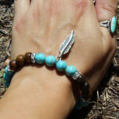 Tigers Eye & Turquoise Feather Bracelet Spiritual Turquoise Beaded Hypoallergenic Bracelet, Spiritual Turquoise Stretch Bracelet, Hypoallergenic Turquoise Beaded Bracelets For Healing, Turquoise Natural Stones Stretch Bracelet For Healing, Turquoise Stretch Bracelet With Natural Stones For Healing, Turquoise Stretch Bracelet For Healing With Natural Stones, Spiritual Turquoise Bracelets For Healing, Turquoise Spiritual Bracelets For Friendship, Spiritual Howlite Beaded Bracelets