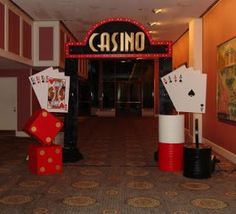 a casino entrance with cards and dice on the floor