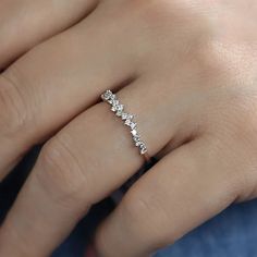 a woman's hand with a diamond ring on it