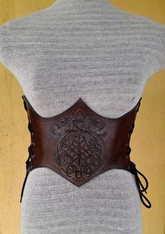 It is Handmade leather corset with Tooled beautiful designs. Handmade and hand dyed belt with high quality leather. It is adjustable with lace.  MEASUREMENTS: S/M : 66 cm - 74 cm / 26" in - 29"in M / L: 75 cm-85 cm / 29.5 "in - 33.5" in L / XL: 85 cm-95  cm / 33.5 "in - 37.4" in DETAILS: ► 100% handmade ► 100% genuine leather ► Made on your measurements ► Unique design ► Battle ready ► LARP standard ► Worldwide delivery NOTE: This item can be personalized on request (contact us) We remind our cu Medieval Style Corset Belt For Festivals, Medieval Corset Belt For Festivals, Gothic Leather Corset Belt, Steampunk Leather Corset Belt For Cosplay, Brown Leather Steampunk Corset Belt, Gothic Brown Corset For Festival, Steampunk Leather Corset Belt For Festivals, Leather Steampunk Corset Belt For Festivals, Gothic Leather Corset Belt For Larp