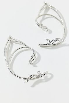 Set of two longline cuff earrings in a pointed silhouette for a magical touch. Features Fey pointed ear cuffs Set of two longline ear cuffs Pointed silhouette Cuff earrings backing Content + Care Set of 2 Mixed metal Avoid contact with water Imported | Fey Pointed Ear Cuff Set in Silver, Women's at Urban Outfitters Silver Hair Cuffs, Elegant Silver Jewelry By Urban Outfitters, Elegant Silver Jewelry From Urban Outfitters, Silver Ear Cuffs, Silver Ear Cuff Earrings, Wire Ear Cuffs, Pointed Ears, Hair Cuffs, Men's Shoes Accessories