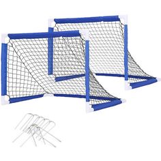 three blue and white soccer goal posts with two sets of pins in front of them