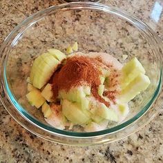 a glass bowl filled with food on top of a counter