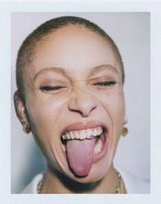 a woman sticking her tongue out with an open mouth