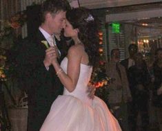 a bride and groom are dancing together at their wedding