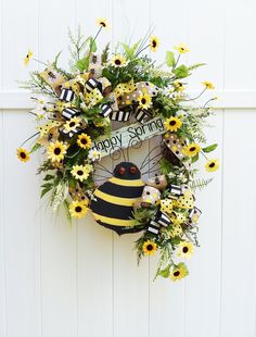 a happy birthday wreath hanging on the side of a white wall with sunflowers