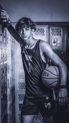 a young man holding a basketball in front of lockers