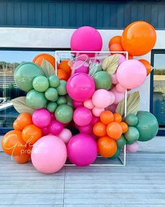 there is a bunch of balloons in the shape of a flower and leaves on display