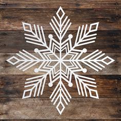 a white snowflake on top of a wooden table