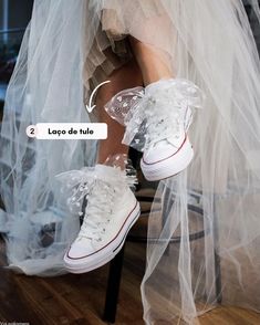 a woman in white shoes is sitting on a chair with a veil over her legs