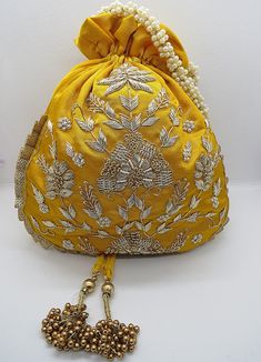 Festive Gold Embroidered Potli Bag, Festive Gold Embroidery Potli Bag, Festive Potli Bag With Gold Embroidery, Traditional Gold Embroidered Potli Bag For Festivals, Traditional Resham Embroidery Potli Bag For Festive Season, Traditional Potli Bag With Gold Embroidery For Festivals, Bollywood Resham Embroidery Potli Bag For Diwali, Traditional Potli Bag With Gold Embroidery For Gifts, Gold Potli Bag With Gota Work For Wedding