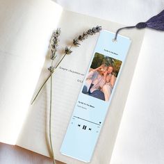 an open book with two pictures on it next to a flower and a pair of headphones