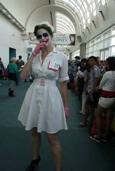 a woman dressed up as the joker poses for a photo