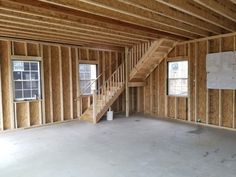 an empty room with stairs and windows in the house that's being built into the wall