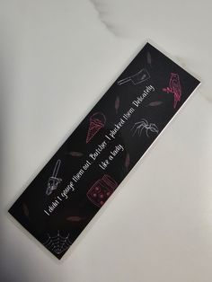 a black and pink sticker with writing on it