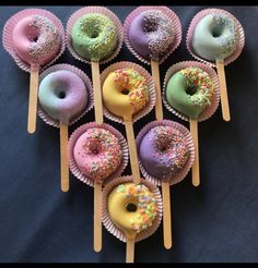 there are many doughnuts on the sticks with sprinkles in them