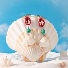 Beachcomber's Bliss: Shell Drop Earrings. Unearth a touch of paradise with our boho earrings. Designed with 18K gold-plated brass and real shells, they whisper luxury with a bohemian soul. Imagine the ocean breeze as these beauties dance with every step. Pair them with our clam shell earrings for a unique mix and match moment, letting you curate your own collection of ocean-inspired treasures. Embrace the free spirit of the coast, one seashell at a time. DETAILS Plating: 18K Gold Materials: 18K Luxury Ocean-inspired Jewelry For Gift, Luxury Ocean-inspired Earrings For Gift, Constellation Earrings, Brass Shell, Everyday Wear Jewelry, Astrology Jewelry, Astrology Necklace, Bohemian Soul, Nature Earrings