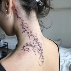 a woman with a tattoo on her neck