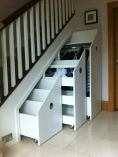 an under stairs storage unit with drawers underneath