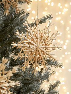 a wooden star ornament hanging from a christmas tree