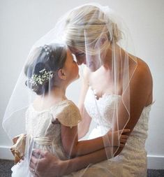 the bride and her daughter are both wearing veils