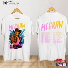 two t - shirts that are on a wooden floor with the words mellow and mccraw printed on them