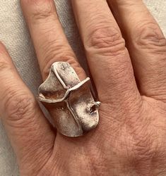 Rare stunning brutalist sterling silver ring made by Finnish designer Bjorn Weckstrom for Lapponia. Multiple hallmarks inside ring band. Chunky I Magma design on substantial heavy band. Made in Finland. Fits approximately a size 6.25 - 6.5. Please measure your finger to fit an 11/16" inside  ring diameter. Measurements: Band approximately 5/16" wide Inside band diameter 11/16" top face measures 1 5/16 x 1/2" high Weighs 16 grams Hallmarks: Manufacturer Mark for Lapponia  925H / Silver Purity Mark  Crown in Heart / Finland National Mark  Helsinki City Mark S7 / Finland Year Mark 1971 BW / Signature Mark for Björn Weckström Sterling Finland Silver Jewelry Design, Ring Band, Jewelry Vintage, Rings Statement, Band Rings, Statement Rings, Silver Ring, Sterling Silver Rings, Vintage Jewelry