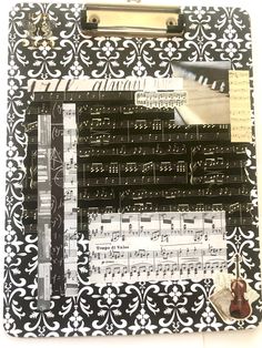 a clipboard with music notes and sheet music on it, attached to a binder