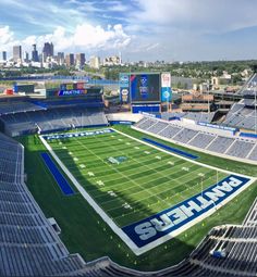 an aerial view of a football stadium with the skyline in the background