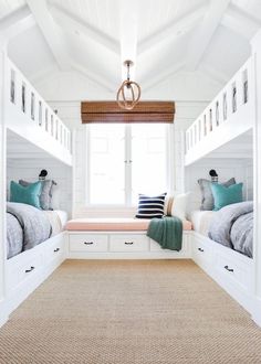 two bunk beds in a room with white walls and carpeted flooring, one bed is on the other side of the room